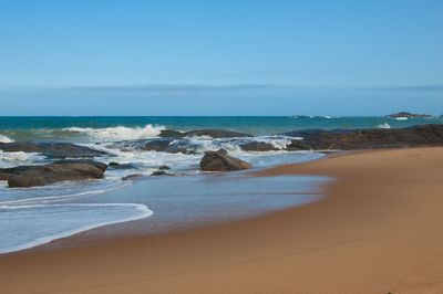 View of beach against blue sky