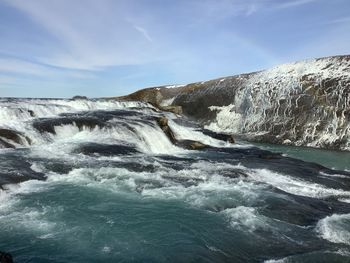 Landscape of part of gullfoss waterfall against the snow capped mountain 