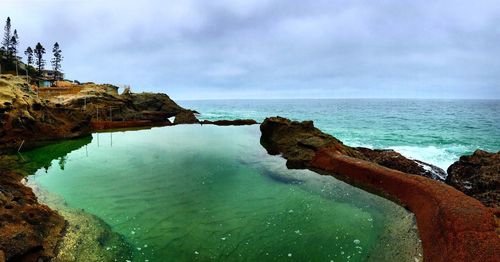 Scenic view of sea against cloudy sky