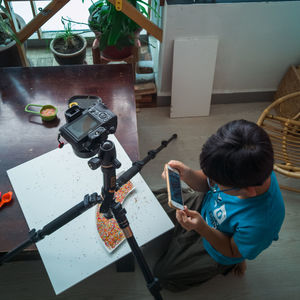 High angle view of girl holding table at home