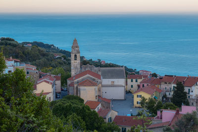 High angle view of townscape by sea against sky