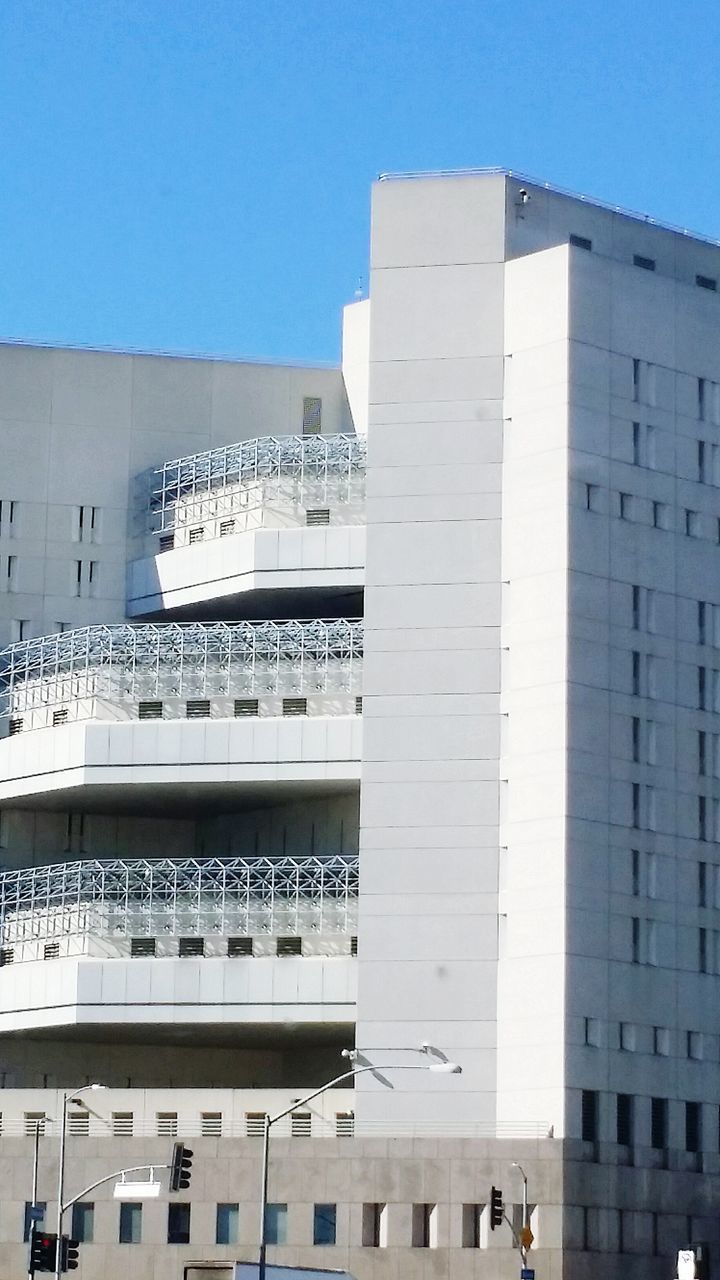 building exterior, architecture, built structure, clear sky, city, building, low angle view, window, modern, office building, residential building, day, in a row, city life, balcony, residential structure, outdoors, sky, exterior, sunlight