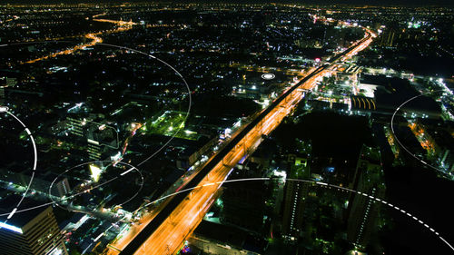 Aerial view of illuminated city buildings at night