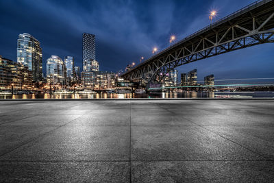 View of illuminated bridge and buildings at night