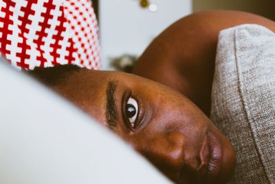 Close-up portrait of young man lying down