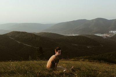 Dog relaxing on grassy field