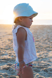 Portrait of young woman standing at beach