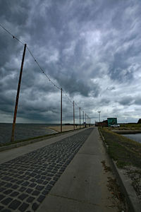 View of bridge over sea against cloudy sky