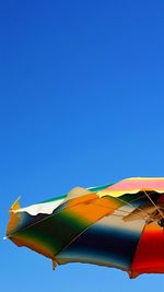 Low angle view of flag against clear blue sky