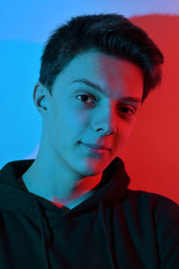 Portrait of teenage boy against wall