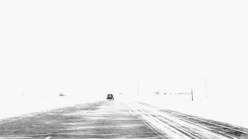 Road against clear sky during winter