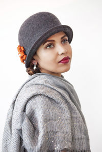 Portrait of woman wearing hat against white background