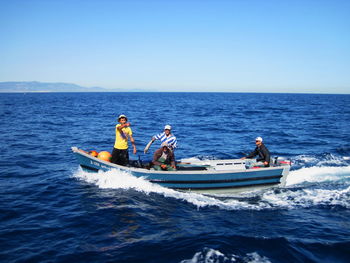 People sitting on boat in sea