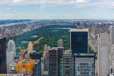 Aerial view of city against cloudy sky