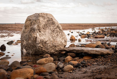 Rocks on beach against sky