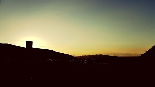 Silhouette of built structure at sunset