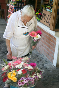 Midsection of woman holding flower bouquet