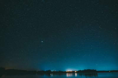 Scenic view of lake against star field at night