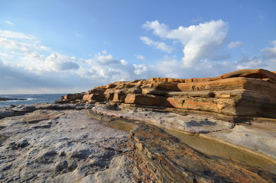 View of rocky shore against the sky