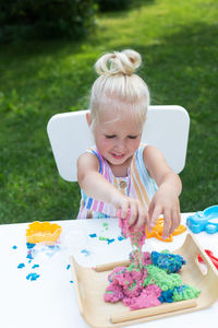 Happy girl playing with baby in the background