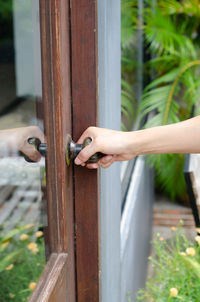 Cropped hand of woman holding door locker