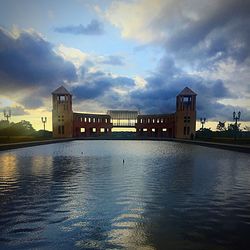 Scenic view of river against sky at sunset