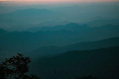 Scenic view of silhouette mountains against sky at dusk