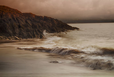 Scenic view of sea against cloudy sky