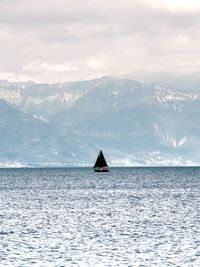 Scenic view of sea and mountains against sky