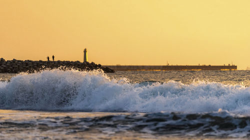 Scenic view of sea against clear sky during sunset