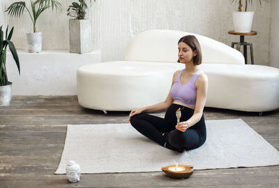 Low section of woman sitting on table