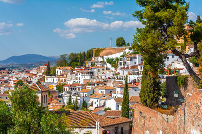 Buildings in town against sky