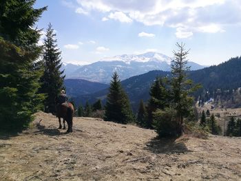 Rear view of people on mountain against sky