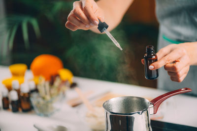 Close-up of person preparing food on table