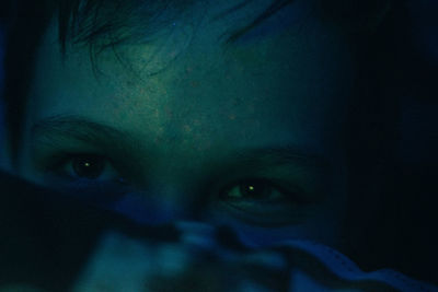 Cropped image of thoughtful girl in darkroom