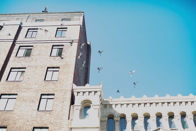 Low angle view of building against clear blue sky