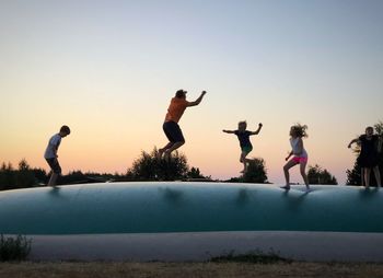 Full length of man jumping against clear sky