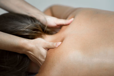 Cropped hands of woman giving massage to customer