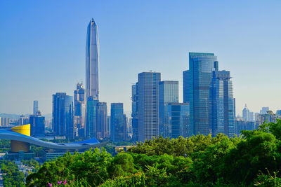 Panoramic view of modern buildings against blue sky