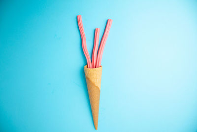 Close-up of colored pencils against blue background