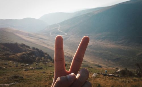 Person on mountain against sky