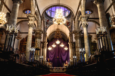 Low angle view of illuminated chandelier in church