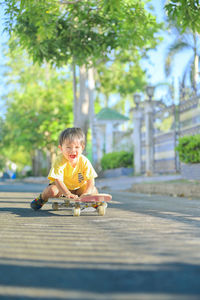 Portrait of boy playing on plant