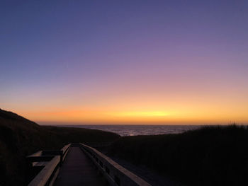 Scenic view of silhouette landscape against clear sky during sunset