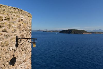 Scenic view of sea and islands with clear blue sky in the bay of naples from castello aragonese