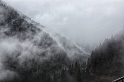 Scenic view of mountains against sky during foggy weather