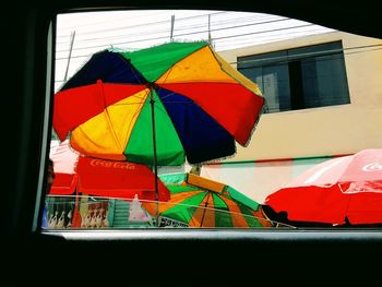 Colorful umbrellas hanging in the dark