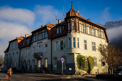 Building by road against sky in city