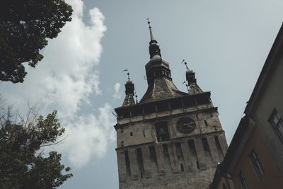 Low angle view of bell tower against sky