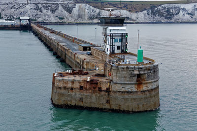 High angle view of rusty pier over sea